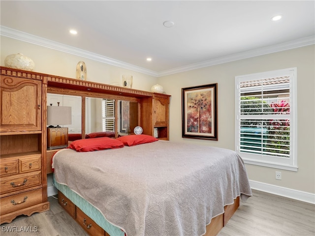 bedroom featuring ornamental molding and light hardwood / wood-style floors