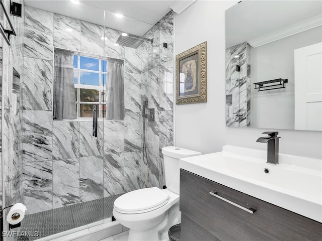 bathroom with toilet, vanity, crown molding, and a tile shower