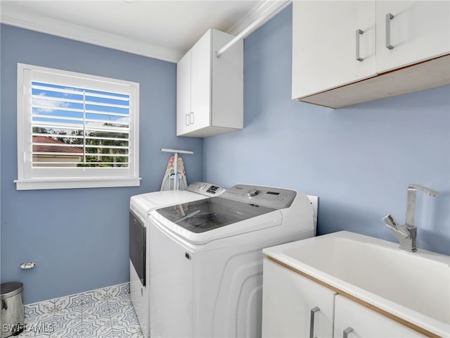 washroom featuring cabinets, separate washer and dryer, and sink