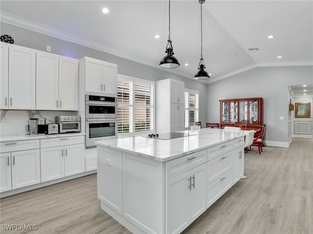 kitchen featuring a center island, pendant lighting, white cabinets, double oven, and black electric cooktop