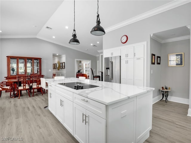 kitchen with black electric cooktop, high end refrigerator, vaulted ceiling, white cabinets, and a center island