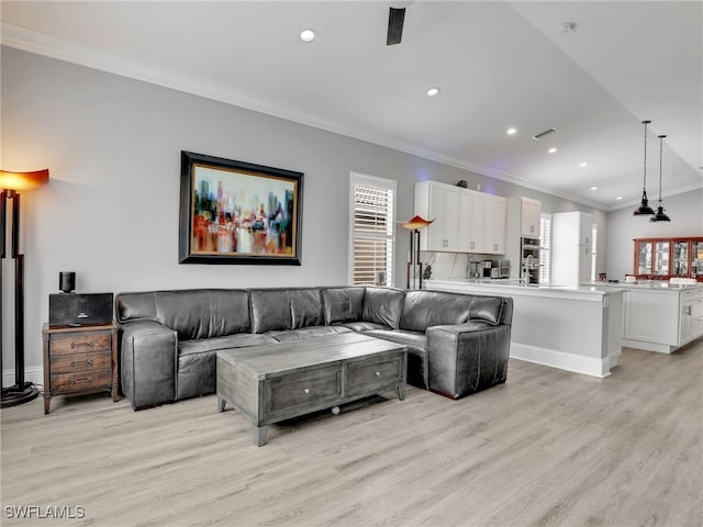 living room featuring ornamental molding and light hardwood / wood-style floors