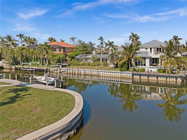 view of dock featuring a lawn and a water view