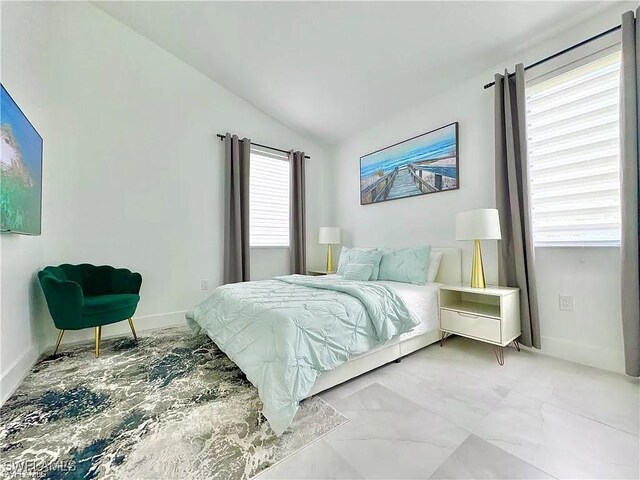 bedroom with multiple windows and vaulted ceiling