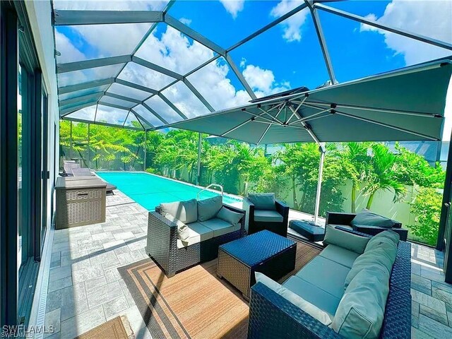 view of patio / terrace with an outdoor living space and glass enclosure