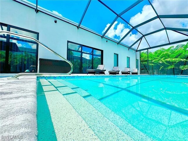 view of swimming pool with a lanai