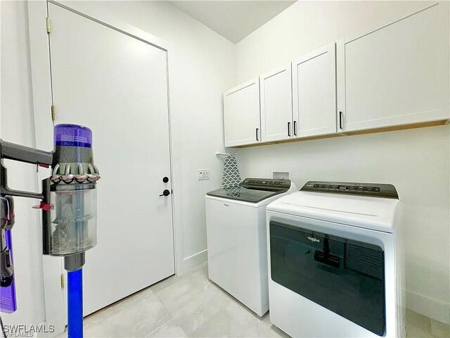 laundry area featuring cabinets and separate washer and dryer