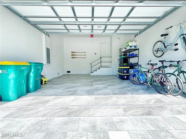 garage with electric panel and a garage door opener