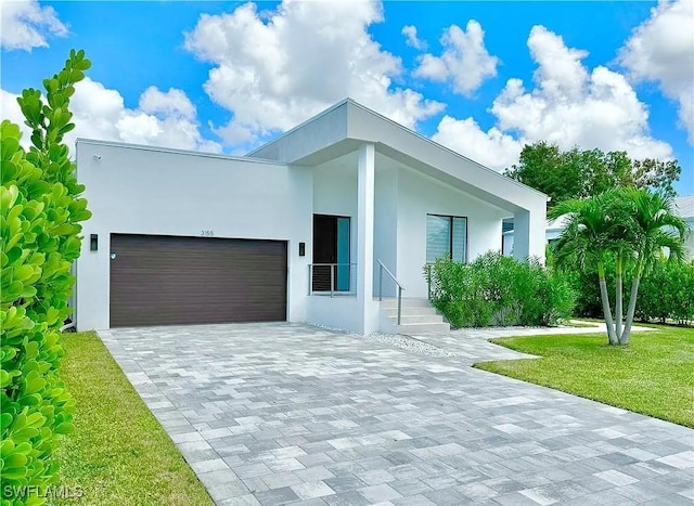 contemporary house featuring a garage and a front yard