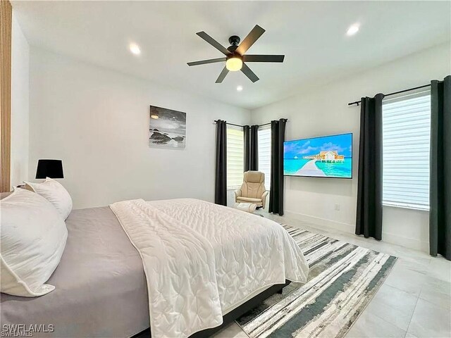 bedroom with ceiling fan and multiple windows