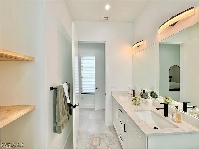 bathroom featuring tile patterned flooring and vanity