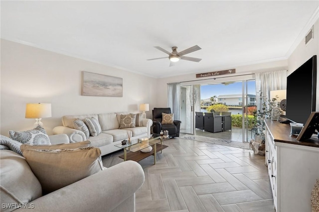 living room featuring ceiling fan, ornamental molding, and light parquet floors