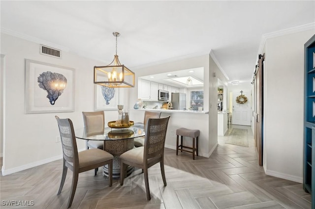 dining room with light parquet flooring, an inviting chandelier, a barn door, and crown molding