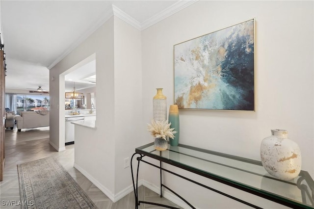 hallway with an inviting chandelier, light parquet floors, and crown molding