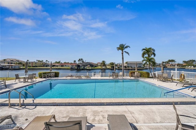 view of swimming pool with a water view and a patio area