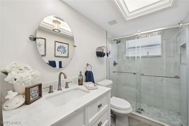 bathroom with a skylight, an enclosed shower, ornamental molding, vanity, and toilet