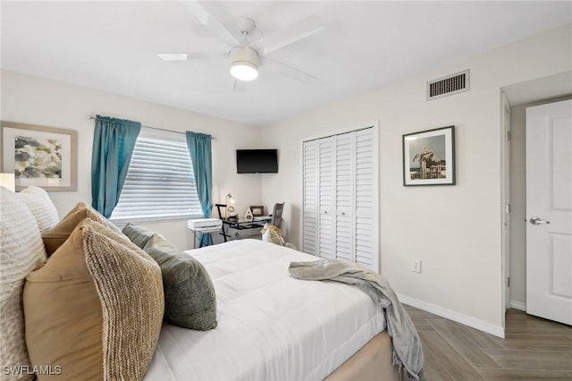 bedroom featuring hardwood / wood-style flooring, ceiling fan, and a closet