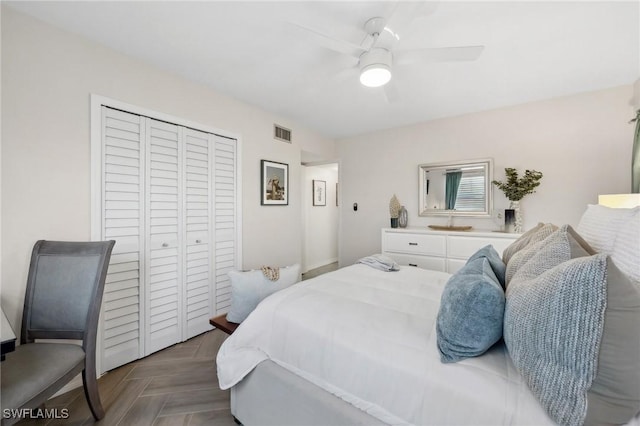 bedroom featuring parquet flooring, a closet, and ceiling fan