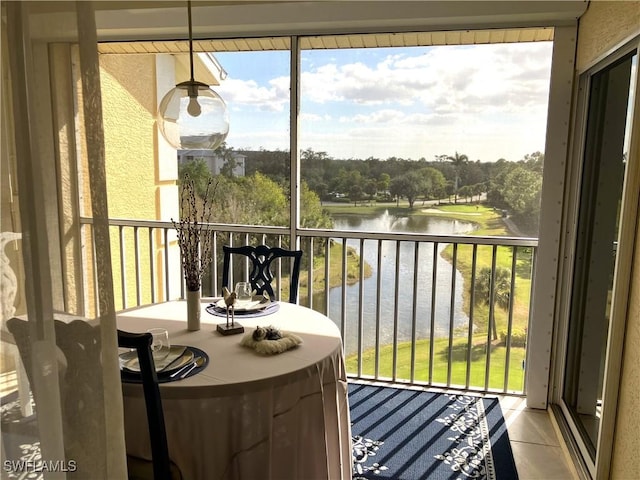 sunroom / solarium with a water view