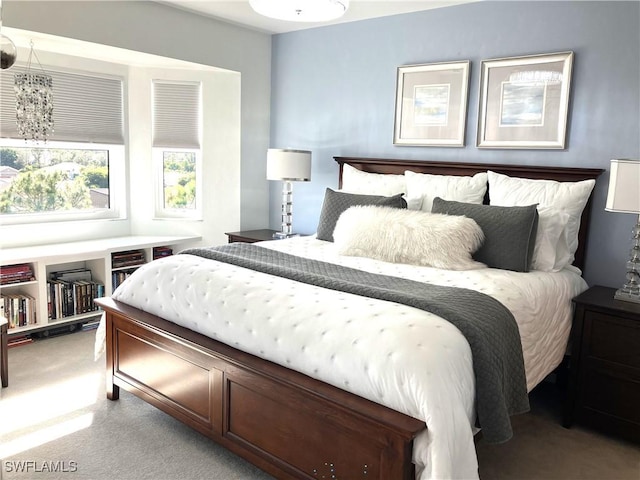 bedroom featuring carpet floors and a notable chandelier