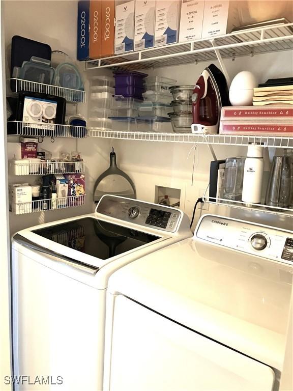 clothes washing area featuring washer and clothes dryer