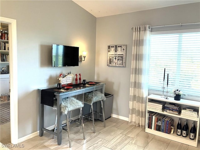 bar with plenty of natural light and baseboards