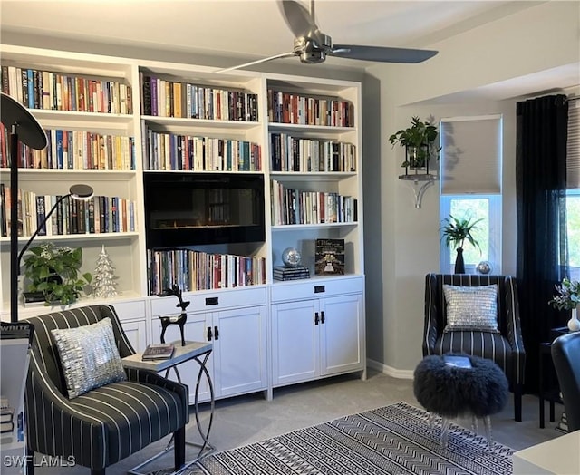 living area with ceiling fan and light carpet