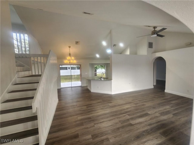 unfurnished living room with dark hardwood / wood-style flooring, high vaulted ceiling, ceiling fan with notable chandelier, and sink