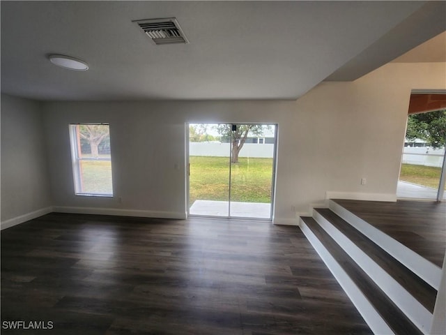 empty room with dark hardwood / wood-style floors