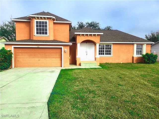 view of front of house featuring a garage and a front lawn