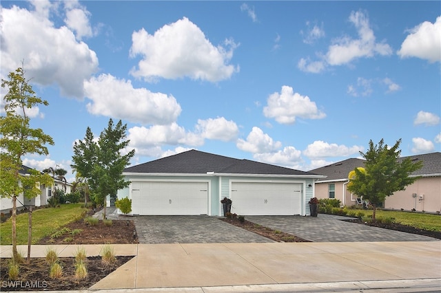 view of front of house with a front lawn and a garage