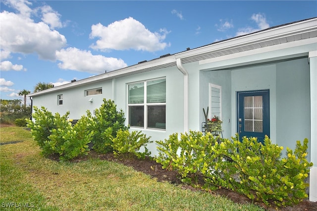 view of side of property with a lawn