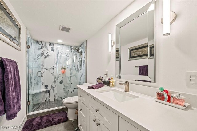 bathroom with tile patterned floors, vanity, toilet, and an enclosed shower