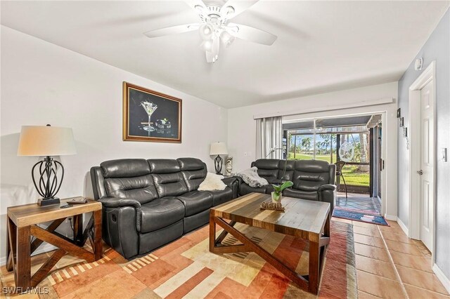 living room with ceiling fan and light tile patterned floors