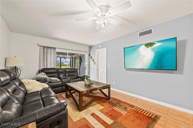 tiled living room with ceiling fan