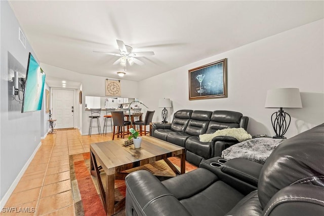 tiled living room featuring ceiling fan