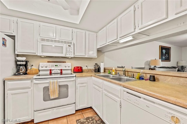 kitchen with white cabinets, white appliances, and sink