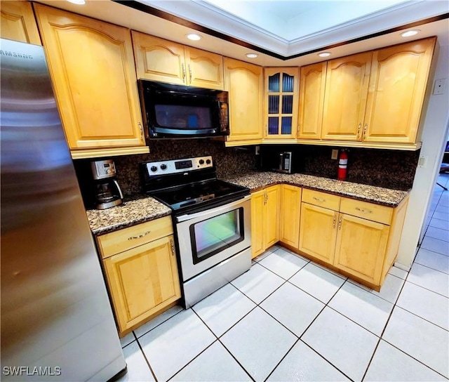 kitchen with decorative backsplash, stainless steel fridge, electric range, and stone countertops