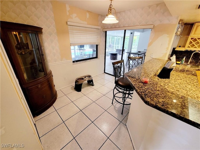 dining area featuring light tile patterned floors and sink