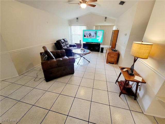 tiled living room with ceiling fan and vaulted ceiling