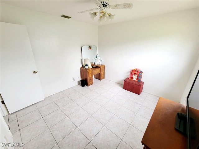 empty room featuring ceiling fan and light tile patterned flooring