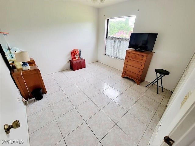 bedroom with light tile patterned floors