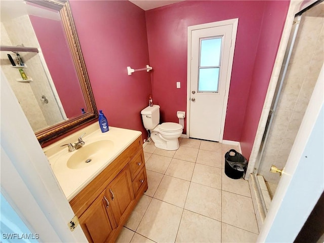 bathroom with tile patterned floors, walk in shower, vanity, and toilet