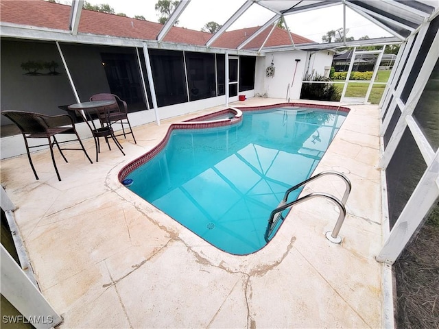 view of swimming pool with a patio and a lanai