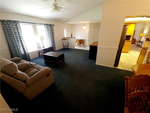 living room featuring carpet flooring, ceiling fan, and lofted ceiling