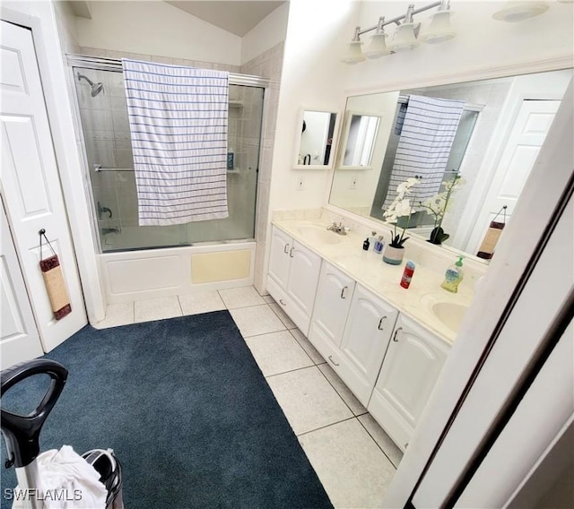 bathroom with tile patterned flooring, vanity, and bath / shower combo with glass door