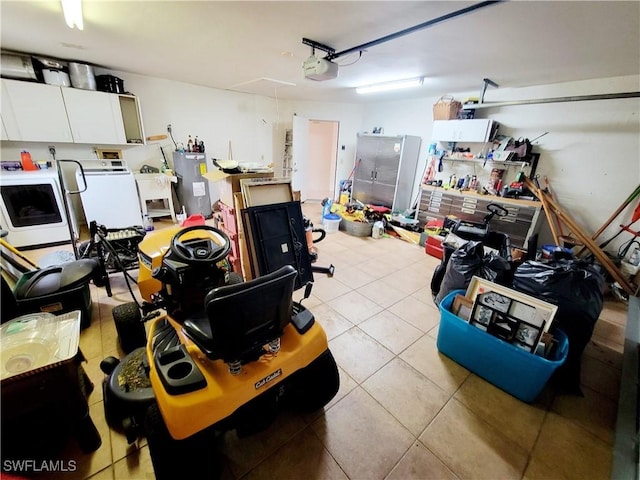 garage with washer and dryer, a garage door opener, and water heater