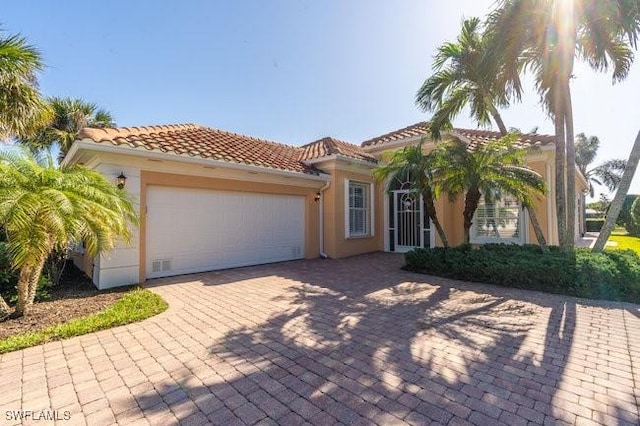 mediterranean / spanish-style home with a garage