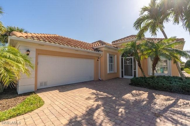 mediterranean / spanish home featuring a garage