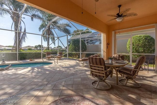 view of patio / terrace featuring a fenced in pool, glass enclosure, and ceiling fan